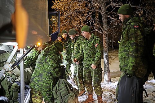 Soldiers with 2nd Battalion, Princess Patricia's Canadian Light Infantry and 1st Regiment, Royal Canadian Horse Artillery grab their personal belongings from the bus after arriving back to CFB Shilo from Latvia late Thursday night following a six-month deployment as part of Operation Reassurance. (Tim Smith/The Brandon Sun)