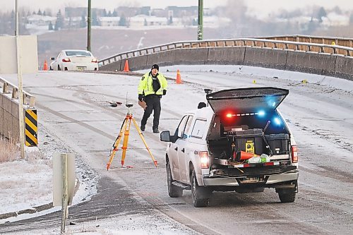 Brandon police survey the Daly Overpass Friday morning following a vehicle-pedestrian collision that took place on the bridge around 6:22 a.m. (Kyle Darbyson/The Brandon Sun)