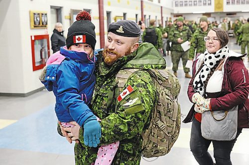 08122022
Sgt. Tyler Perry with 1st Regiment, Royal Canadian Horse Artillery, carries his daughter Amelia followed by his wife Madison after arriving back to CFB Shilo from Latvia late Thursday night along with fellow troops from 2PPCLI and the 1RCHA following a six month deployment as part of Operation Reassurance. Over 500 troops have been returning home from Shilo over the past few weeks with approximately 120 arriving home Thursday. Other troops from Shilo deployed to Latvia in recent days as part of the ongoing operation. 
(Tim Smith/The Brandon Sun)