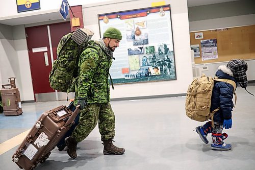 Six-year-old Hudson Sparks carries his dad's backpack. Master Cpl. Rory Sparks with 2nd Battalion, Princess Patricia's Canadian Light Infantry, returned to CFB Shilo from Latvia late Thursday night. (Tim Smith/The Brandon Sun)