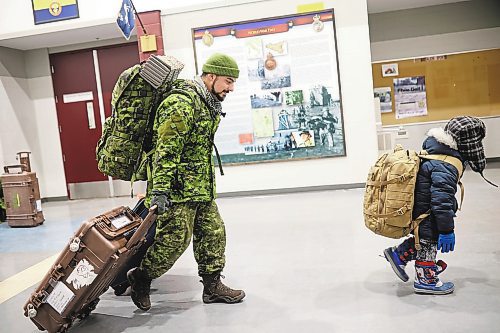 08122022
Six-year-old Hudson Sparks carries his dad's backpack after MCpl Rory Sparks (L) with 2nd Battalion, Princess Patricia's Canadian Light Infantry, arrived back to CFB Shilo from Latvia late Thursday night along with fellow troops from 2PPCLI and the 1st Regiment, Royal Canadian Horse Artillery after a six month deployment as part of Operation Reassurance. Over 500 troops have been returning home from Shilo over the past few weeks with approximately 120 arriving home Thursday. Other troops from Shilo deployed to Latvia in recent days as part of the ongoing operation. 
(Tim Smith/The Brandon Sun)