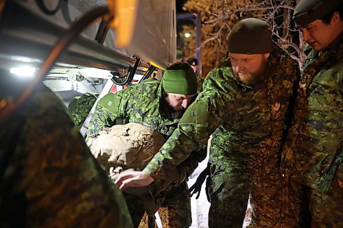 08122022
Soldiers with 2nd Battalion, Princess Patricia's Canadian Light Infantry and 1st Regiment, Royal Canadian Horse Artillery grab their personal belongings from the bus after arriving back to CFB Shilo from Latvia late Thursday night following a six month deployment as part of Operation Reassurance. Over 500 troops have been returning home from Shilo over the past few weeks with approximately 120 arriving home Thursday. Other troops from Shilo deployed to Latvia in recent days as part of the ongoing operation. 
(Tim Smith/The Brandon Sun)