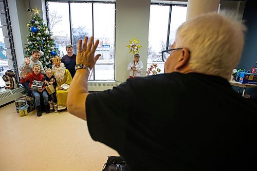 Daniel Crump / Winnipeg Free Press. Norbert Iwan takes photos of a Ukrainian family with St. Mykolai during an event for Ukrainian kids, most of whom are recently arrived new comers, at the Oseredok Ukrainian Cultural and Educational Centre. December 10, 2022.