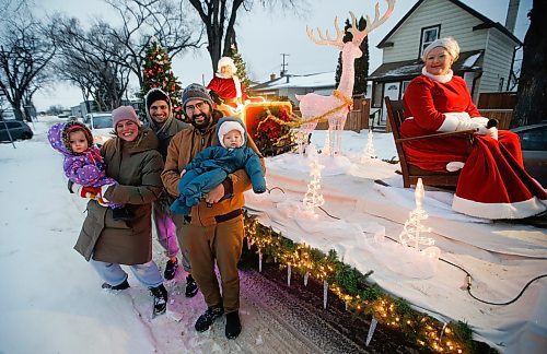 JOHN WOODS / WINNIPEG FREE PRESS
Terry, Crystal and their child River, left, and Mike and his child Lena Currie pose with Santa and Mrs Claus as they visited Clifton St in the West End and waved to the residents Sunday, December 11, 2022. 

Re: standup?