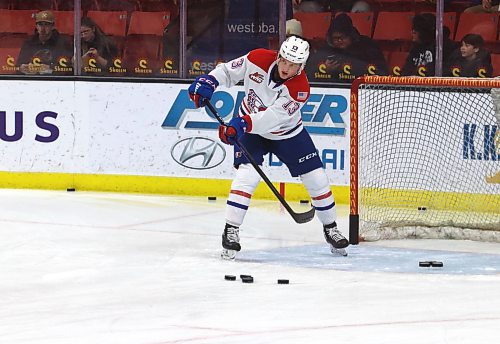 Grady Lane, shown pulling pucks out of the net and distributing them for a drill, is a heart-and-soul player, according to Spokane head coach Ryan Smith. (Perry Bergson/The Brandon Sun)