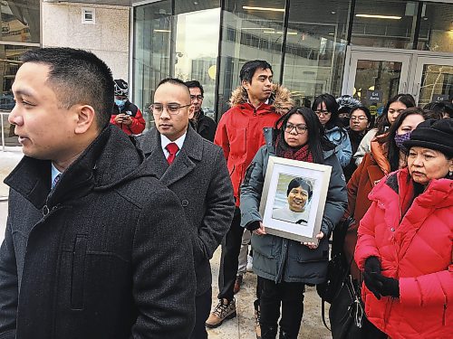Dean Pritchard / Winnipeg Free Press
Edward Balaquit (left) along with family and friends outside the Law Courts Monday, after Kyle Pietz was given a 16-year prison sentence after being found guilty of manslaughter for Eduardo Balaquit.
