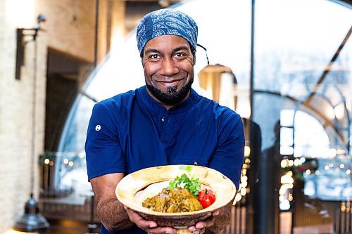 MIKAELA MACKENZIE / WINNIPEG FREE PRESS

Rob Thomas poses for a photo with his curry chicken for a global Christmas in Winnipeg on Friday, Dec. 9, 2022. For AV Kitching story.
Winnipeg Free Press 2022.