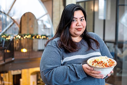 MIKAELA MACKENZIE / WINNIPEG FREE PRESS

Jennie A Ramos poses for a photo with her Filipino spaghetti for a global Christmas in Winnipeg on Friday, Dec. 9, 2022. For AV Kitching story.
Winnipeg Free Press 2022.