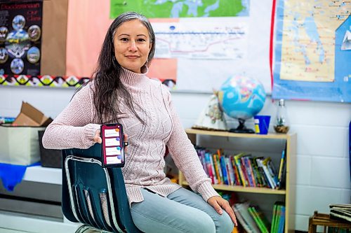 MIKAELA MACKENZIE / WINNIPEG FREE PRESS

Jennifer Lamoureux, divisional teacher team leader for Indigenous Education in Seven Oaks, poses for a portrait with the new language app in the Indigenous education room at Riverbend Community School in Winnipeg on Monday, Dec. 12, 2022. For Maggie story.
Winnipeg Free Press 2022.