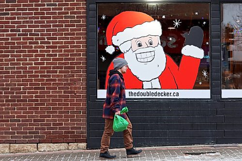 12122022
A pedestrian walks past a festive Santa window mural at The Double Decker on 10th Street in Brandon on Monday. (Tim Smith/The Brandon Sun)