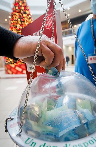JOHN WOODS / WINNIPEG FREE PRESS
A person deposits a donation into the Salvation Army Christmas fundraising kettle at Polo Park shopping centre Tuesday, December 13, 2022. 

Re: ?