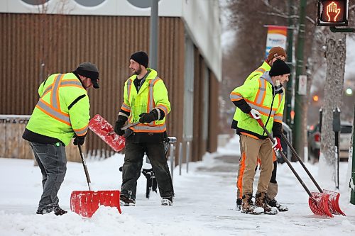 City of Brandon workers clean the sidewalks of freshly fallen snow around the A.R. McDiarmid Civic Complex in downtown Brandon on Wednesday morning. (Tim Smith/The Brandon Sun)