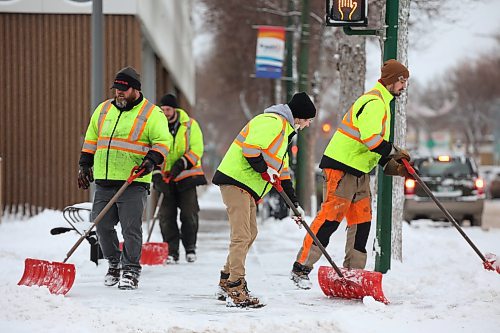 14122022
City of Brandon workers clean the sidewalks of freshly fallen snow around the A. R. McDiarmid Civic Complex in downtown Brandon on Wednesday morning.
(Tim Smith/The Brandon Sun)