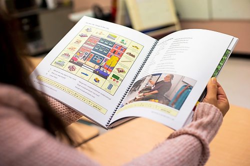 MIKAELA MACKENZIE / WINNIPEG FREE PRESS

Jennifer Lamoureux, divisional teacher team leader for Indigenous Education in Seven Oaks, shows the Anishinaabemowin dictionary at Riverbend Community School in Winnipeg on Monday, Dec. 12, 2022. For Maggie story.
Winnipeg Free Press 2022.