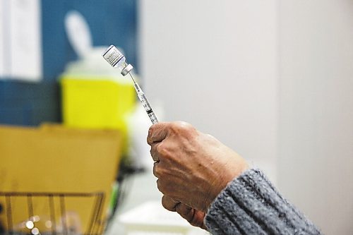 MIKE DEAL / WINNIPEG FREE PRESS
Registered nurse, Irene Par&#xe9;, loads her needles with the Pfizer BioNTech vaccine at her station before the start of her day Friday morning.
Ma Mawi Wi Chi Itata Centre vaccine clinic at 363 McGregor Street, brings in a lot of community support and Indigenous tradition including a morning smudge of the vaccines. The atmosphere of togetherness and one-on-one support has helped many in the area who may be wary of getting the vaccine.
See Melissa Martin story
220121 - Friday, January 21, 2022.