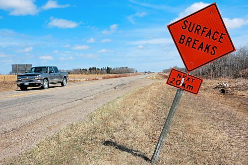A pickup truck travels along Provincial Road 353, north of Brandon, past a sign warning of the poor road conditions, in this file image. (File/The Brandon Sun)