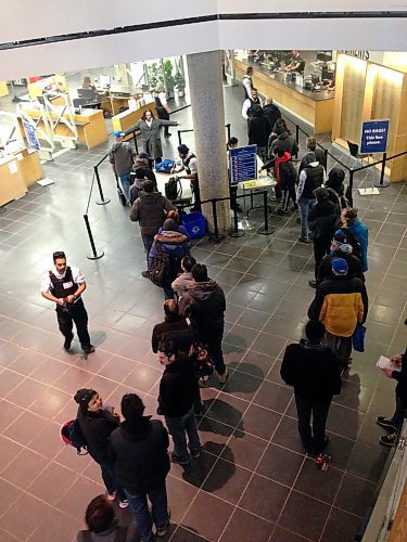 CARL DEGURSE / WINNIPEG FREE PRESS

Patrons at the Millennium Library are searched before entry on Saturday, March 23, 2019.  The searches include searching bags with sticks, making patrons empty their pockets, and using metal-detector wands to check for weapons.