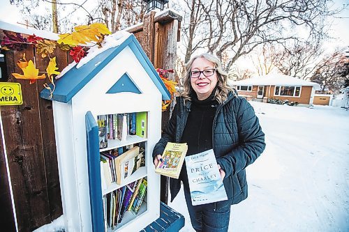 MIKAELA MACKENZIE / WINNIPEG FREE PRESS

Lisa Feyereisen poses for a photo with her little free library on Rossmere Crescent  in Winnipeg on Wednesday, Dec. 7, 2022. For Rachel story.
Winnipeg Free Press 2022.