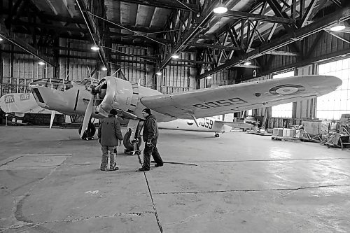 Art Brown (left) and John McNarry (right) inspect their work after moving a Bristol Bolingbroke plane in the hangar of the Commonwealth Air Training Plan Museum on Friday. (Colin Slark/The Brandon Sun)