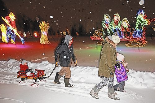 16122022
Dustin Troop and Crystal Donley enjoy a family walk through the snow with their children Ashton and Tayleah at the Brandon Skating Oval on a snowy Friday evening. (Tim Smith/The Brandon Sun)