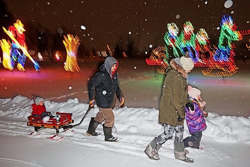 16122022
Dustin Troop and Crystal Donley enjoy a family walk through the snow with their children Ashton and Tayleah at the Brandon Skating Oval on a snowy Friday evening. (Tim Smith/The Brandon Sun)