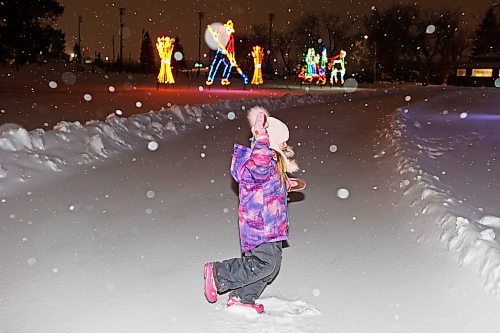 16122022
Tayleah Troop spins on the snow-covered ice at the Brandon Skating Oval while out for a walk with family on a snowy Friday evening. (Tim Smith/The Brandon Sun)