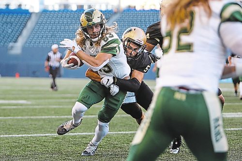 Daniel Crump / Winnipeg Free Press. Rams receiver Riley Boersma (83) is tackled by Bisons defensive back  Nick Conway (5) as the University of Manitoba Bisons take on the University of Regina Rams at IG Field in Winnipeg. September 2, 2022.