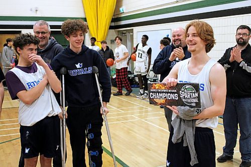 Mike McDougall, left, laughs as his teammate Jackson Doak poses for photos following the Selkirk Royals 86-54 win over the Linden Christian Wings in the Brandon Sun Spartan Invitational Tier 2 final. (Lucas Punkari/The Brandon Sun) 