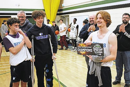 Mike McDougall, left, laughs at his teammate Jackson Doak as he poses for photos following the Selkirk Royals 86-54 win over the Linden Christian Wings in the Brandon Sun Spartan Invitational Tier 2 final. (Lucas Punkari/The Brandon Sun) 