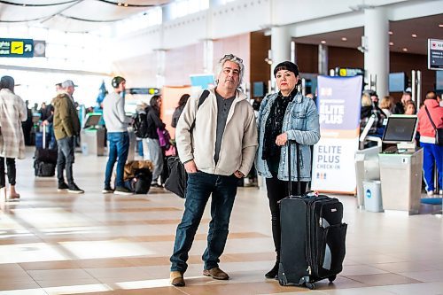 MIKAELA MACKENZIE / WINNIPEG FREE PRESS

Dave Wilder and Karin Phillips, who are stuck in Winnipeg when they should be on their honeymoon due to a flight cancellation, pose for a photo while waiting at the airport in Winnipeg on Tuesday, Dec. 20, 2022.  For Kevin Rollason story.
Winnipeg Free Press 2022.