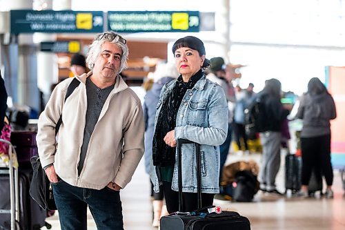 MIKAELA MACKENZIE / WINNIPEG FREE PRESS

Dave Wilder and Karin Phillips, who are stuck in Winnipeg when they should be on their honeymoon due to a flight cancellation, pose for a photo while waiting at the airport in Winnipeg on Tuesday, Dec. 20, 2022.  For Kevin Rollason story.
Winnipeg Free Press 2022.