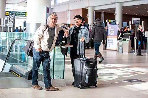 MIKAELA MACKENZIE / WINNIPEG FREE PRESS

Dave Wilder and Karin Phillips, who are stuck in Winnipeg when they should be on their honeymoon due to a flight cancellation, pose for a photo while waiting at the airport in Winnipeg on Tuesday, Dec. 20, 2022.  For Kevin Rollason story.
Winnipeg Free Press 2022.