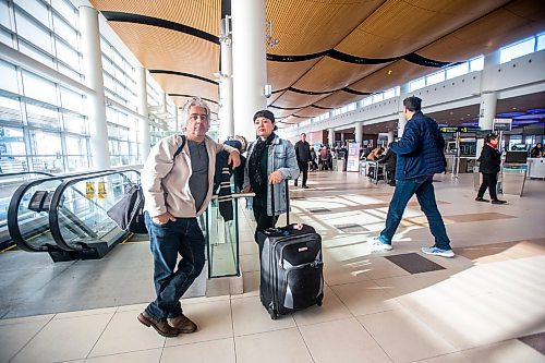 MIKAELA MACKENZIE / WINNIPEG FREE PRESS

Dave Wilder and Karin Phillips, who are stuck in Winnipeg when they should be on their honeymoon due to a flight cancellation, pose for a photo while waiting at the airport in Winnipeg on Tuesday, Dec. 20, 2022.  For Kevin Rollason story.
Winnipeg Free Press 2022.