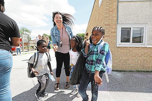 RUTH BONNEVILLE / WINNIPEG FREE PRESS

Local - School's Out!

Caitlin Engel, who teaches early school years at St. George School celebrates with her students, Dayo, Joanna and Ayobami (left - right) as they say goodbye on their last day of school on Thursday afternoon.  

Subject: Students/parents celebrating the end of the 2021-22 year at St. George School in the Louis Riel School Division.?

SCHOOL WRAP: For the first time in three years, students and teachers are bidding farewell to their 2021-22 classrooms with traditional goodbyes &#x2014; field days and family barbecues among them. Teachers are reporting extra exhaustion this year, given students haven&#x2019;t had to have the stamina to study in-person in both May and June since late 2019. Stopping by a school this afternoon to take some shots of happy kids who are excited for the summer.

Reporter info: Maggie Macintosh  

June 30th, 2022