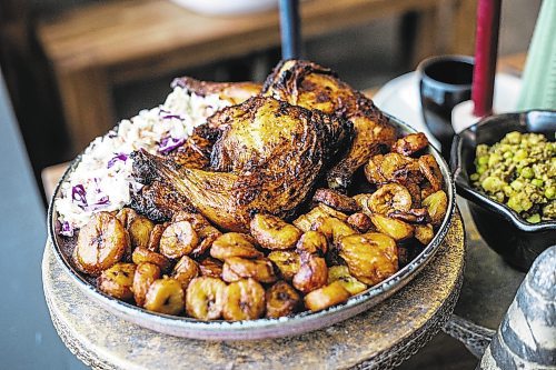 MIKAELA MACKENZIE / WINNIPEG FREE PRESS

A global Christmas dinner table with chicken, plaintain, and coleslaw in Winnipeg on Friday, Dec. 9, 2022. For AV Kitching story.
Winnipeg Free Press 2022.