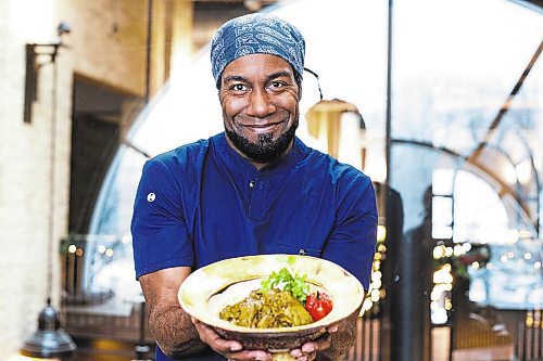 MIKAELA MACKENZIE / WINNIPEG FREE PRESS

Rob Thomas poses for a photo with his curry chicken for a global Christmas in Winnipeg on Friday, Dec. 9, 2022. For AV Kitching story.
Winnipeg Free Press 2022.