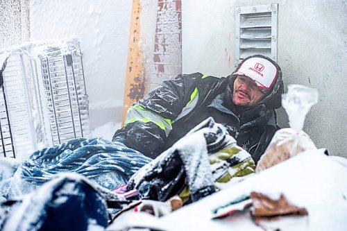 MIKAELA MACKENZIE / WINNIPEG FREE PRESS

Daniel Lamirante huddles by a warm air vent outside of Siloam Mission on a very cold day in Winnipeg on Wednesday, Dec. 21, 2022. For Tyler story.
Winnipeg Free Press 2022.