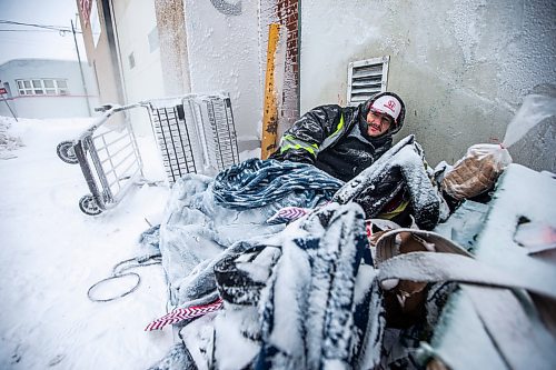 MIKAELA MACKENZIE / WINNIPEG FREE PRESS

Daniel Lamirante huddles by a warm air vent outside of Siloam Mission on a very cold day in Winnipeg on Wednesday, Dec. 21, 2022. For Tyler story.
Winnipeg Free Press 2022.