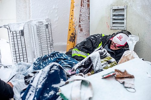 MIKAELA MACKENZIE / WINNIPEG FREE PRESS

Daniel Lamirante huddles by a warm air vent outside of Siloam Mission on a very cold day in Winnipeg on Wednesday, Dec. 21, 2022. For Tyler story.
Winnipeg Free Press 2022.