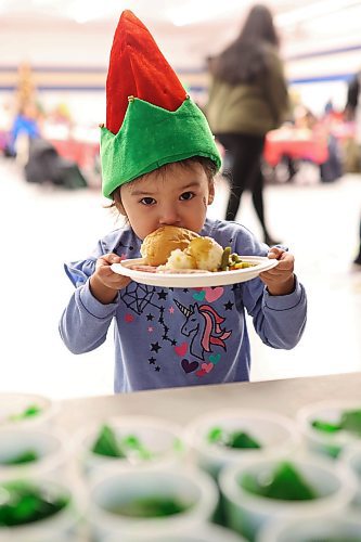 Three-year-old Rain Wasicuna holds a plate filled with food during the annual Christmas dinner at the Sioux Valley Dakota Nation Veterans Hall on Thursday evening. (Tim Smith/The Brandon Sun)