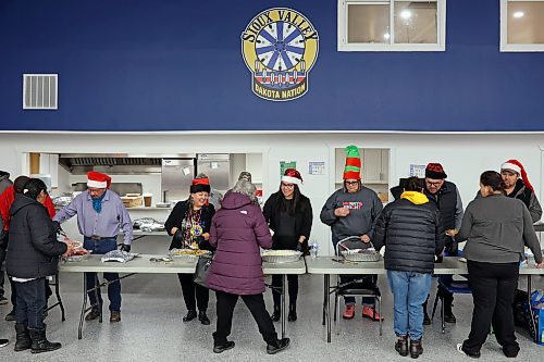 Members of Sioux Valley Dakota Nation’s chief and council as well as community directors serve dinner to community members during the Christmas dinner at the SVDN Veterans Hall on Thursday evening. (Tim Smith/The Brandon Sun)