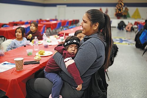 22122022
A tuckered out Forrest Elk Hotain sleeps in the arms of her mother, Lauren Elk, during the annual Christmas Dinner at the SVDN Veterans Hall on Thursday evening. Sioux Valley also held dinners in Winnipeg and Brandon for members of the First Nation in those cities earlier this month and will hold a final dinner today for community elders. This was the first community Christmas Dinner in three years at Sioux Valley as the dinners for 2020 and 2021 were cancelled due to the COVID-19 pandemic.  (Tim Smith/The Brandon Sun)