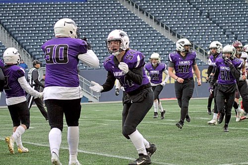Lucas Burgoyne (54) and Scott Sherb celebrate a third-down stop by the Vincent Massey Vikings defence during their Winnipeg High School Football League Division 2 semifinal at IG Field in Winnipeg. (Thomas Friesen/The Brandon Sun)