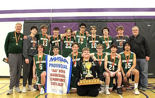 The Neelin Spartans pose with the championship banner and trophy at varsity boys AAA basketball provincials after beating Louis-Riel 84-66 in the final. (Thomas Friesen/The Brandon Sun)