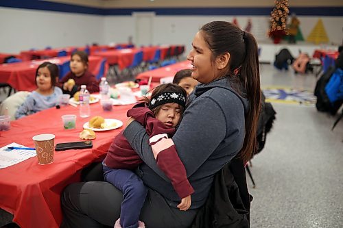 22122022
A tuckered out Forrest Elk Hotain sleeps in the arms of her mother, Lauren Elk, during the annual Christmas Dinner at the SVDN Veterans Hall on Thursday evening. Sioux Valley also held dinners in Winnipeg and Brandon for members of the First Nation in those cities earlier this month and will hold a final dinner today for community elders. This was the first community Christmas Dinner in three years at Sioux Valley as the dinners for 2020 and 2021 were cancelled due to the COVID-19 pandemic.  (Tim Smith/The Brandon Sun)