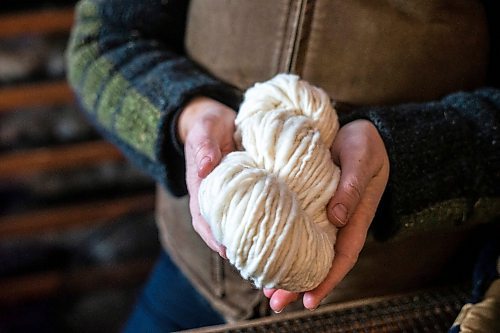 MIKAELA MACKENZIE / WINNIPEG FREE PRESS

Anna Hunter, co-director of Pembina Fibreshed, shows a skein of local wool at her mill east of Winnipeg on Tuesday, Dec. 6, 2022. For green page story.
Winnipeg Free Press 2022.