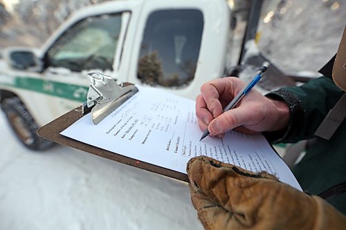 On a clipboard page, Parks Canada resource conservation officer Tim Town notes the number and variety of birds seen during a four-kilometre hike around the Bead Lakes Trail in Riding Mountain National Park on Tuesday, as part of the annual Christmas Bird Count. (Matt Goerzen/The Brandon Sun)