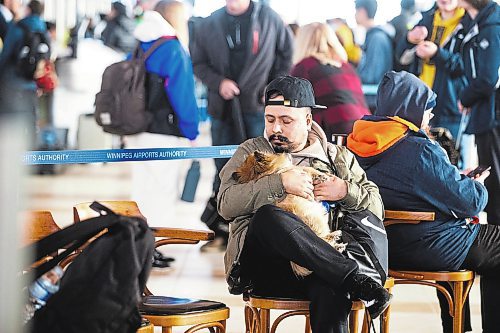 MIKAELA MACKENZIE / WINNIPEG FREE PRESS

Sunny Kalsi and his dog, Toffifee, wait (they were flying to Thunder Bay, but got stuck here and are trying to get back to Edmonton and locate lost luggage, which has many family Christmas presents) at the Winnipeg Richardson International Airport in Winnipeg on Friday, Dec. 23, 2022. For Katie story.
Winnipeg Free Press 2022.