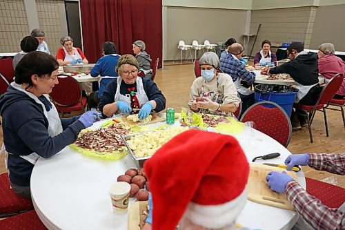 Paula Stirling, Kim McKee and Gerry Gebhardt peel and dice potatoes on Friday alongside other volunteers helping to prepare for the Westman and Area Traditional Christmas Dinner at the Keystone Centre. The dinner runs from noon to 6 p.m. on Christmas Day. (Tim Smith/The Brandon Sun)