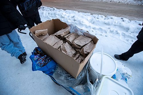 Daniel Crump / Winnipeg Free Press. Volunteers from Warmer Hearts Winnipeg hand out hot chocolate, soup, and clothing to anyone who wants some in downtown Winnipeg. December 24, 2022.